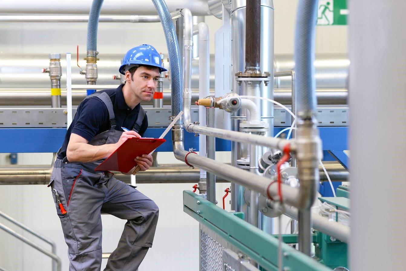 Technician inspects a factory installation
